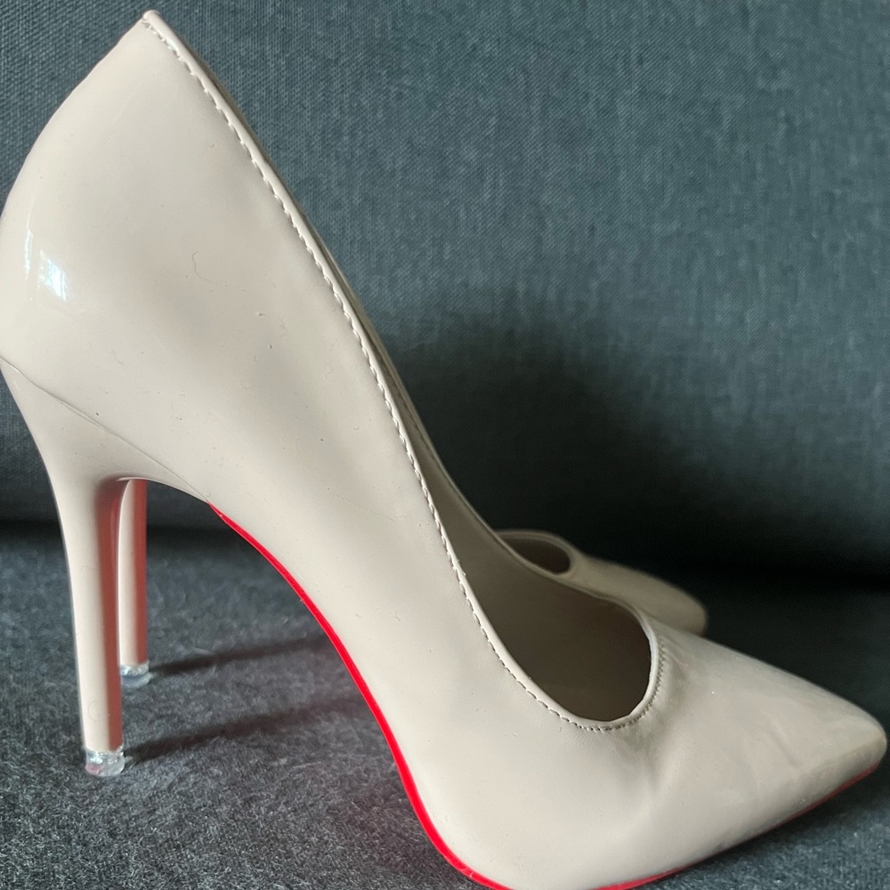Tan pump heels with red bottoms
